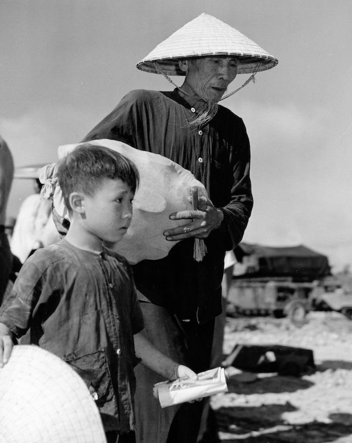 Refugees wait to board a boat from North to South Vietnam, September 1954. US Navy Medicine. Public Domain.
